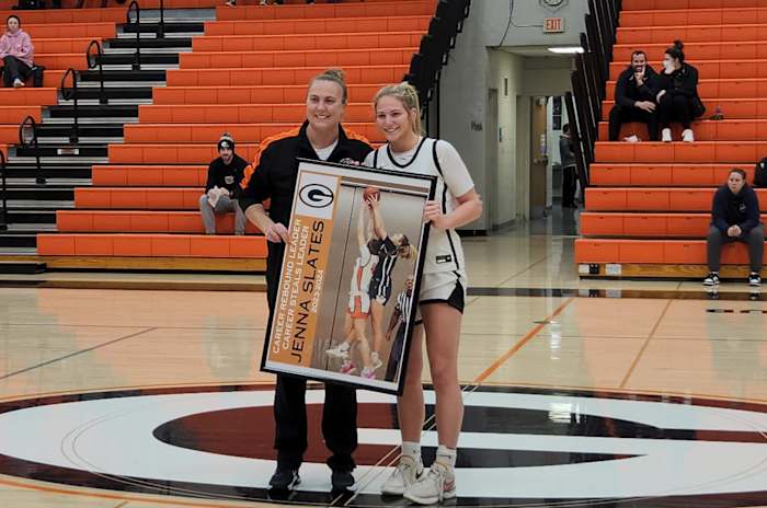 Green Junior Jenna Slates poses with head coach Alicia Manning after breaking the Green girls basketball career rebounding record in a game against Solon on Monday, January 8, 2024. Photo credit: Ryan Isley, SBLive Sports